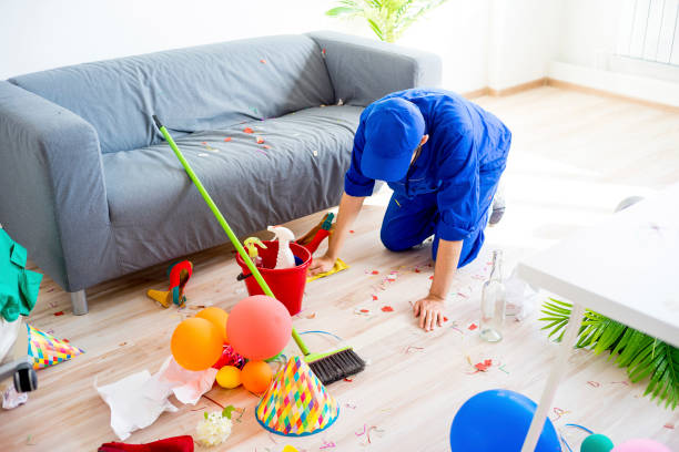 A janitor is cleaning a mess after a party